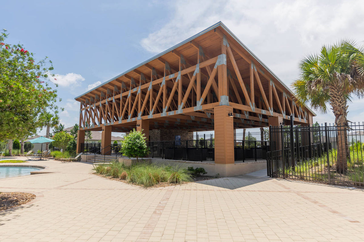 The timber pavilion from the pool deck, its trusses joined with galvanized steel plates