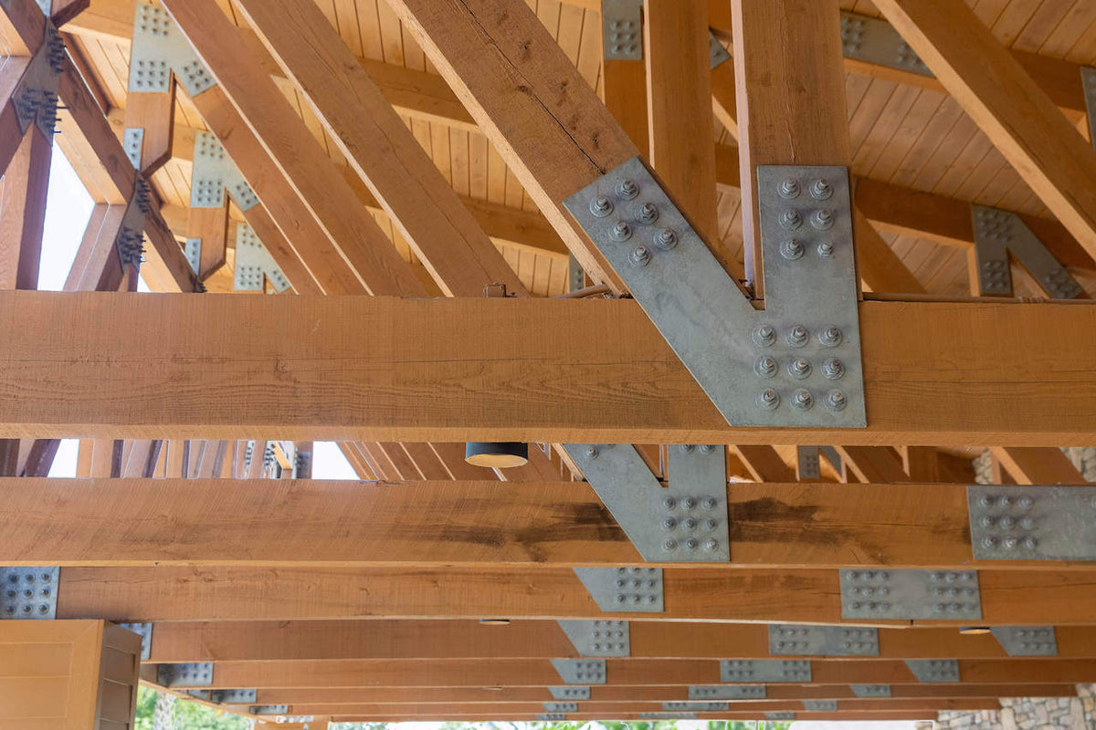 Close-up of galvanized steel plates bolted at the truss joints