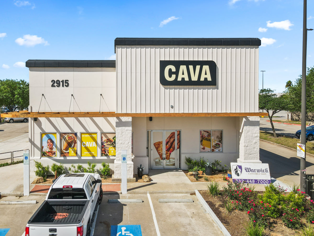 Front of the League City CAVA, with the tie-rod-supported timber awning running along the side wall